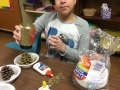 Sunday School Children making Christmas trees  from pine cones for church members