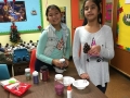 Sunday School Children making Christmas trees  from pine cones for church members