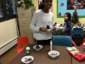 Sunday School Children making Christmas trees  from pine cones for church members